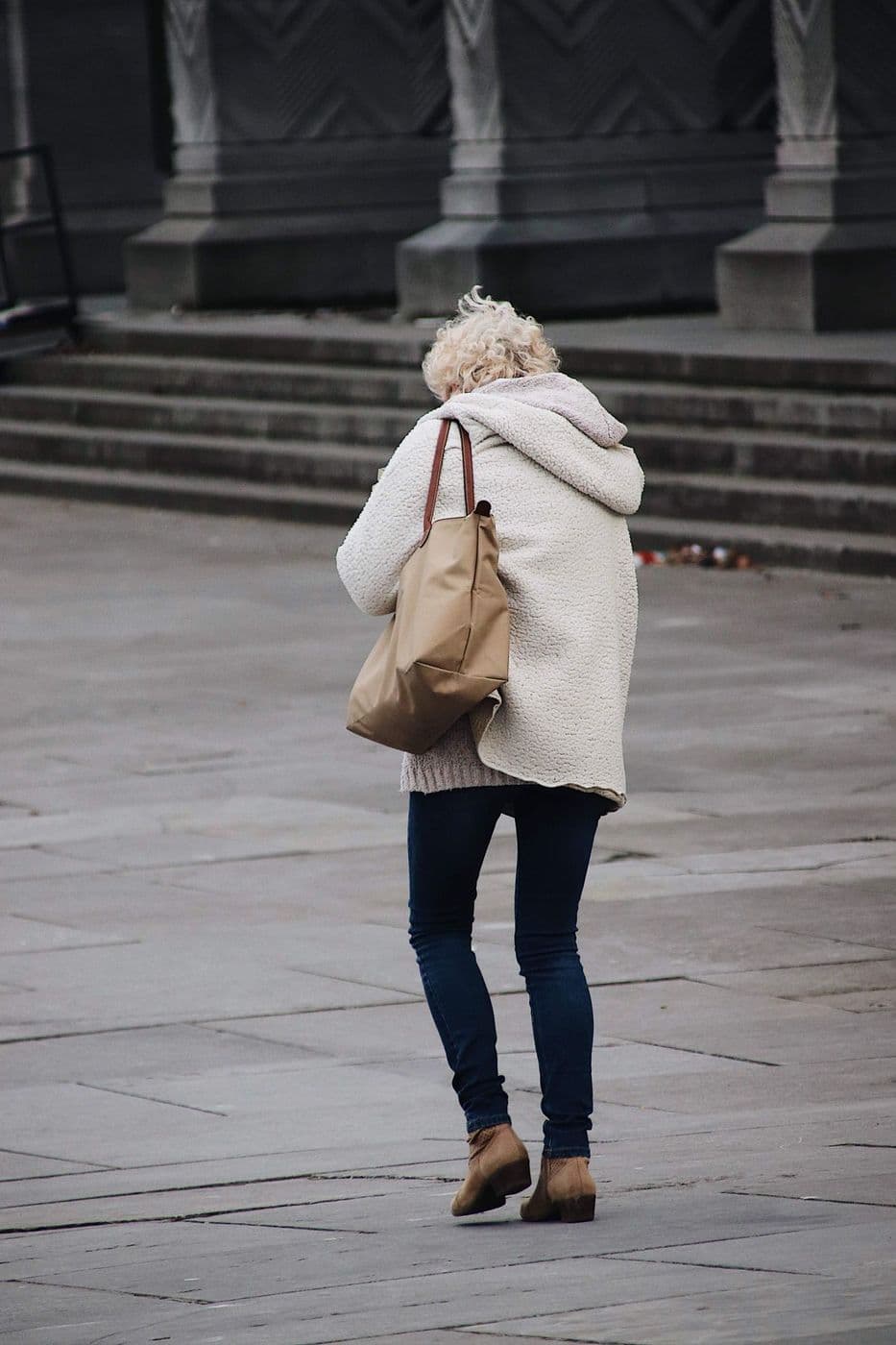 Woman walking through the city with a shoulder bag